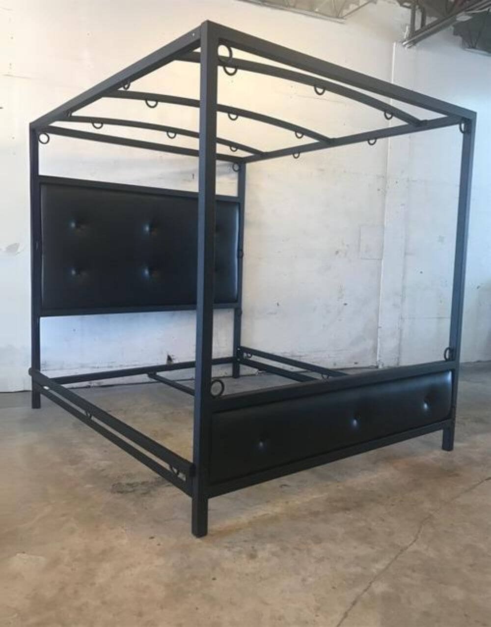 The Phantom Bed by Metalbound: a luxurious upholstered bed frame designed for comfort and style, featuring multiple attachment points for secure and versatile bondage play.