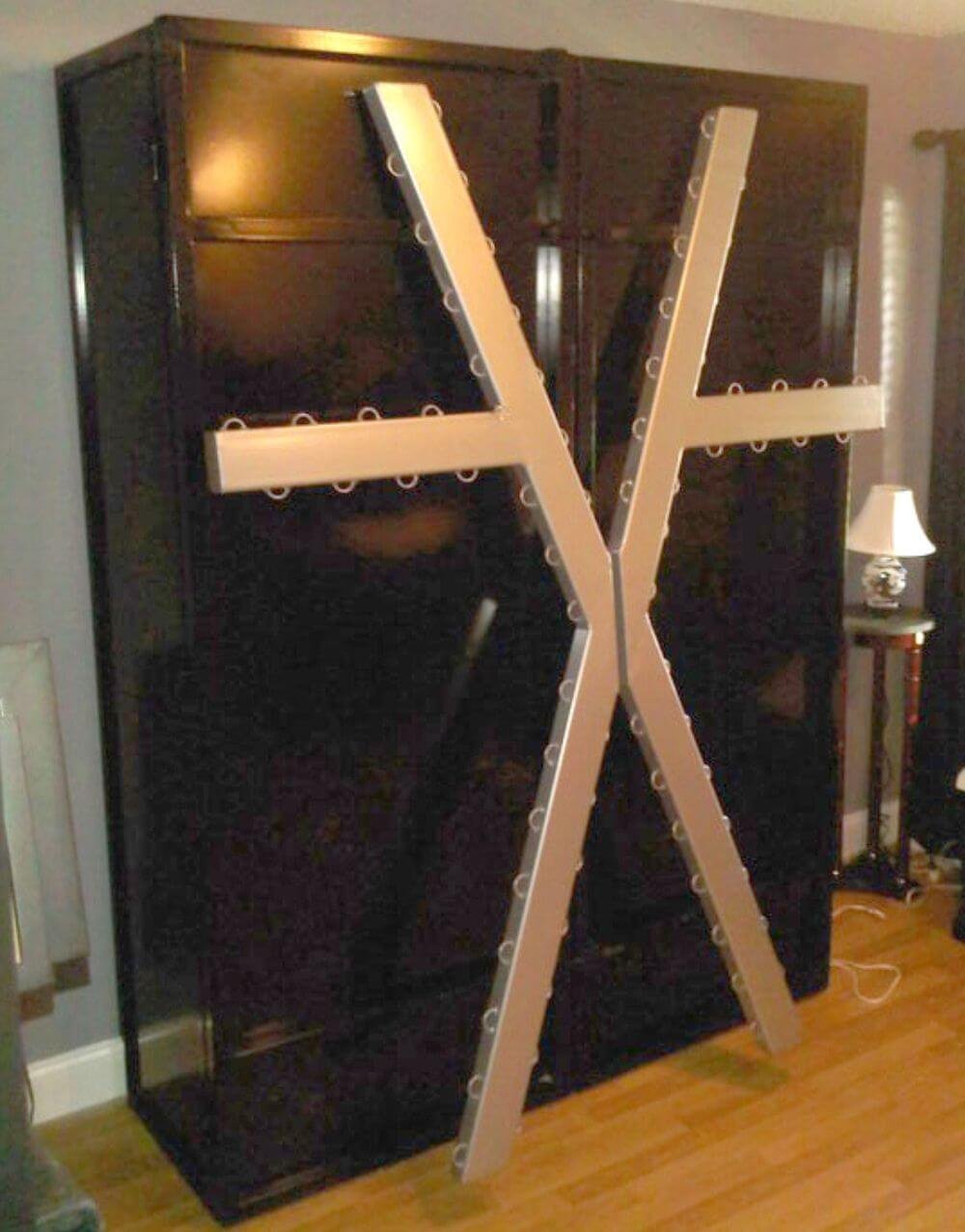 Cross Cabinet by Metalbound: a unique and versatile storage cabinet featuring a cross design, perfect for securely storing bondage equipment and accessories.