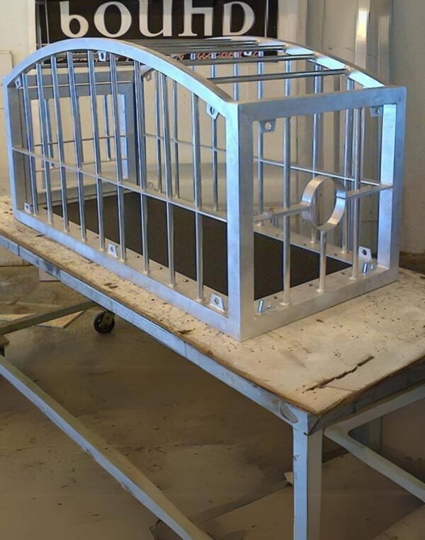 Round Top Puppy Cage with Stockade by Metalbound: a durable metal cage with a rounded top, featuring an integrated stockade for versatile restraint options and secure containment during bondage play.