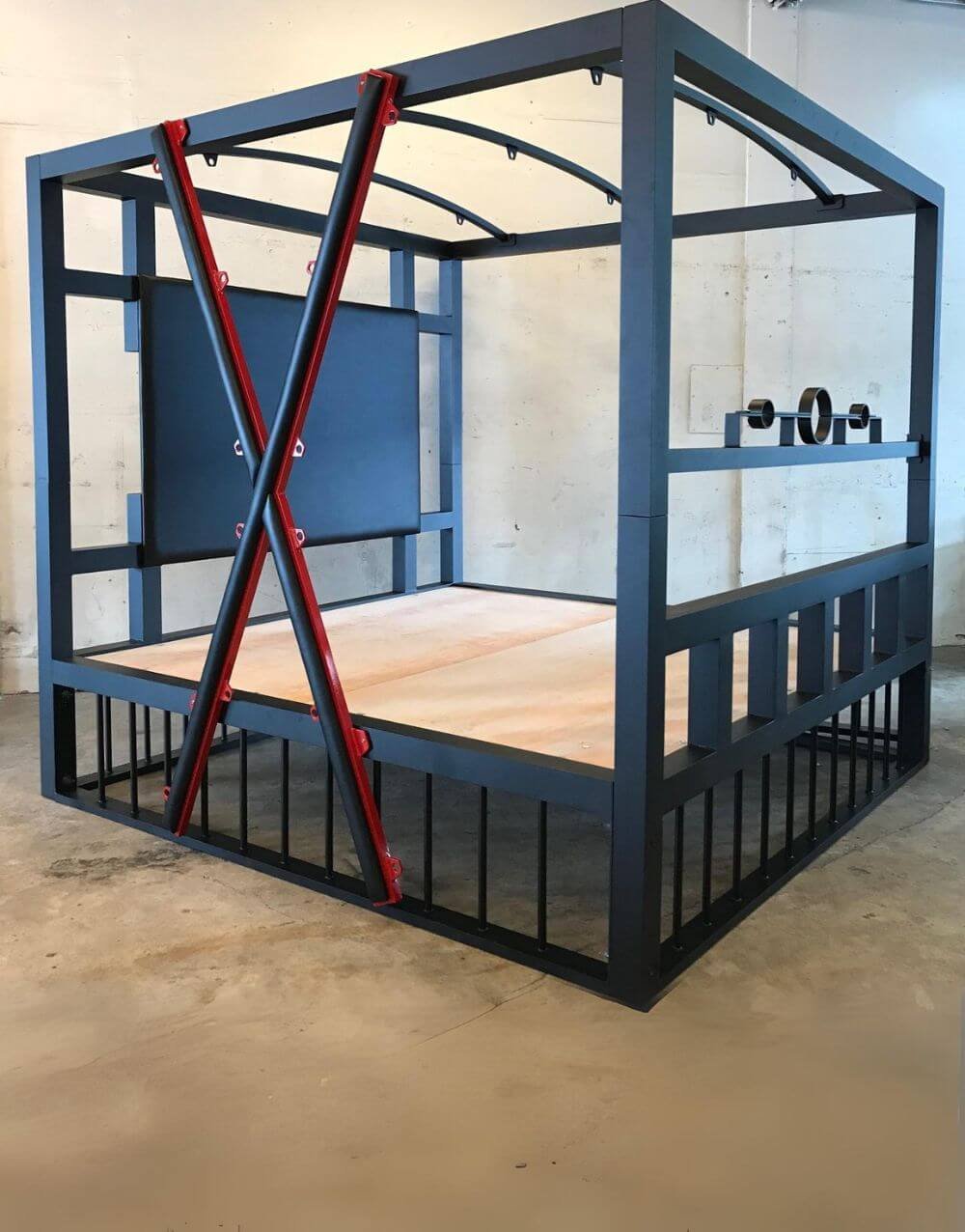 All In Bed by Metalbound featuring a removable stockade and cross for versatile BDSM play.