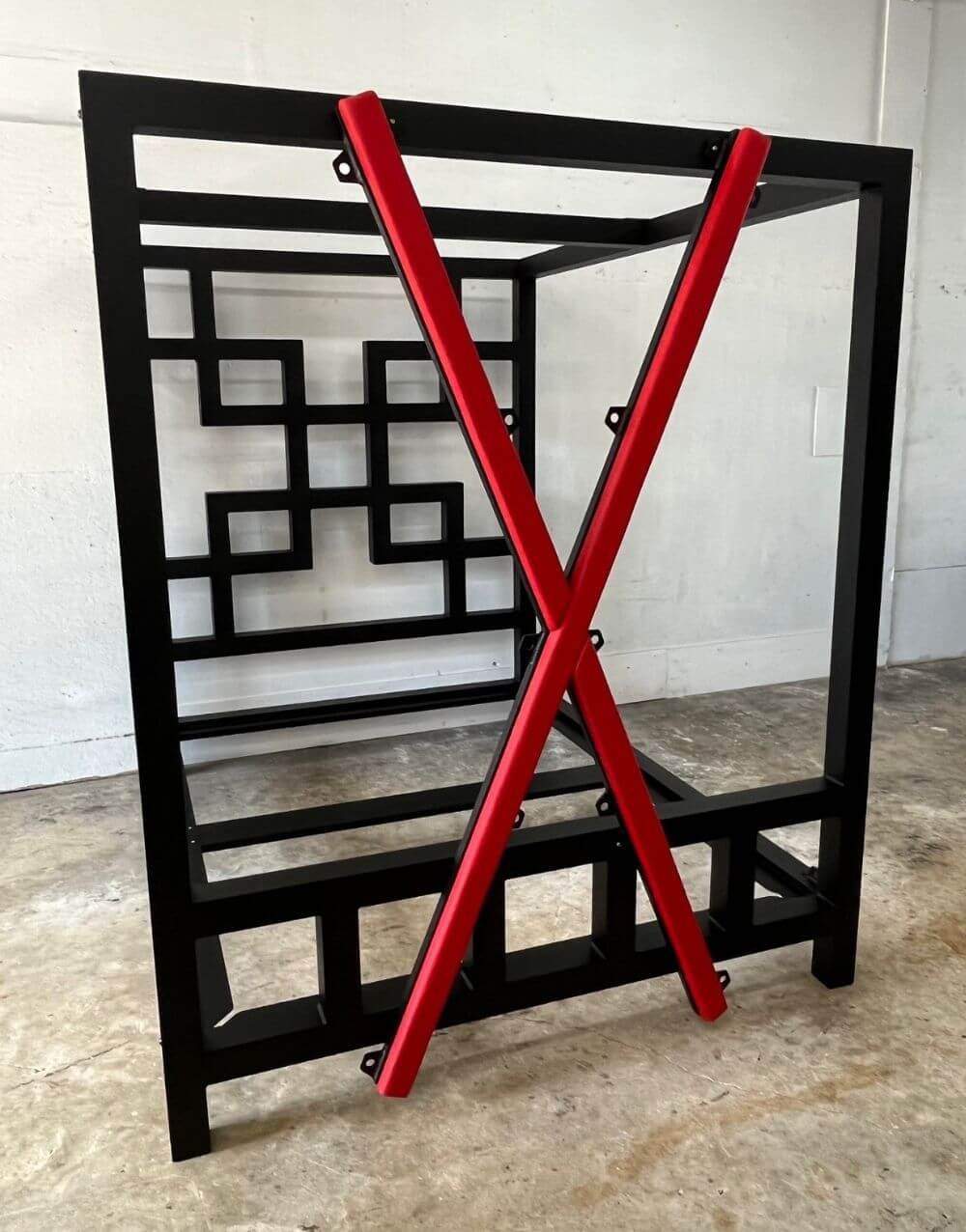 The East Meets West bed in black with a red removable cross.